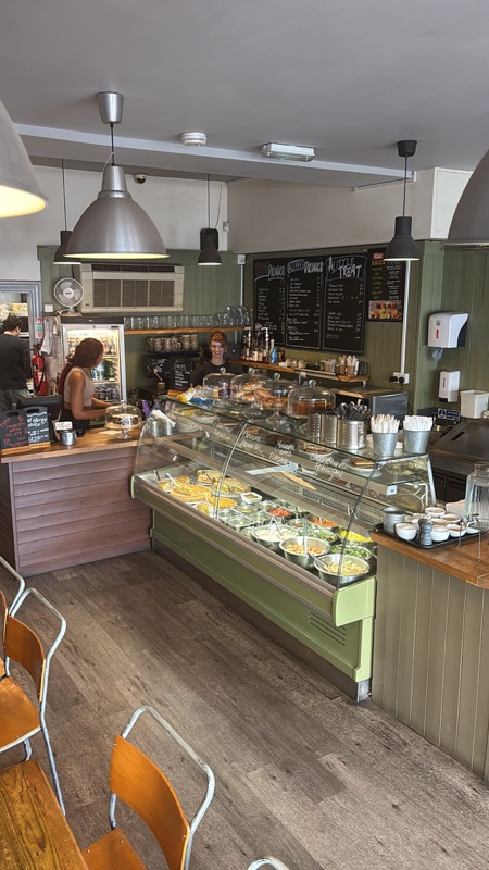 The salad bar and cake counter at Crumbs Kitchen, with the day's quiches, salads and cakes under glass domes
