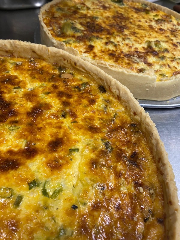 Two deep golden quiches fresh from the oven